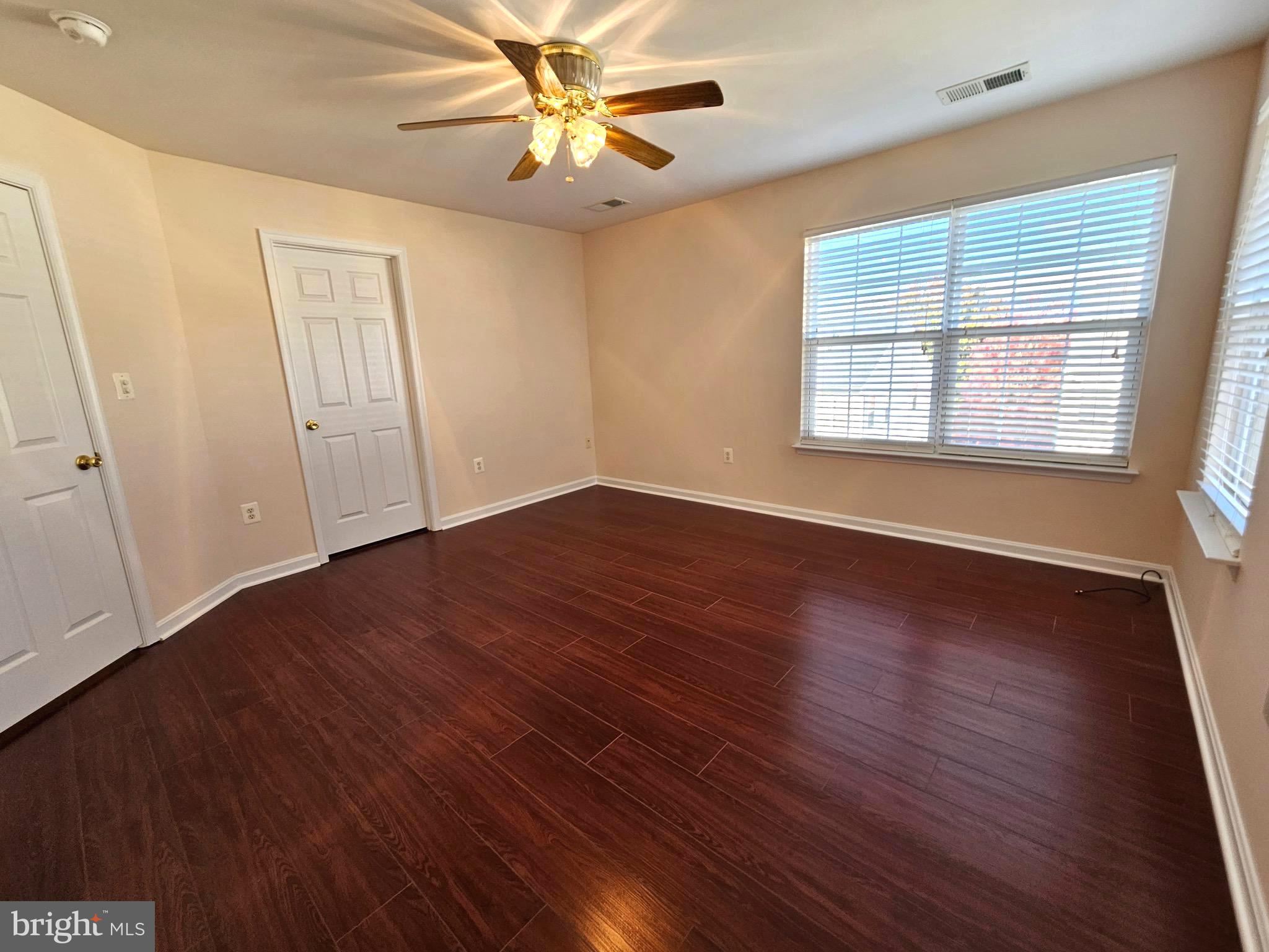 2238 Blue Spruce Drive Culpeper, VA 22701 - Photo 15 of 18 a view of an empty room with wooden floor and a window