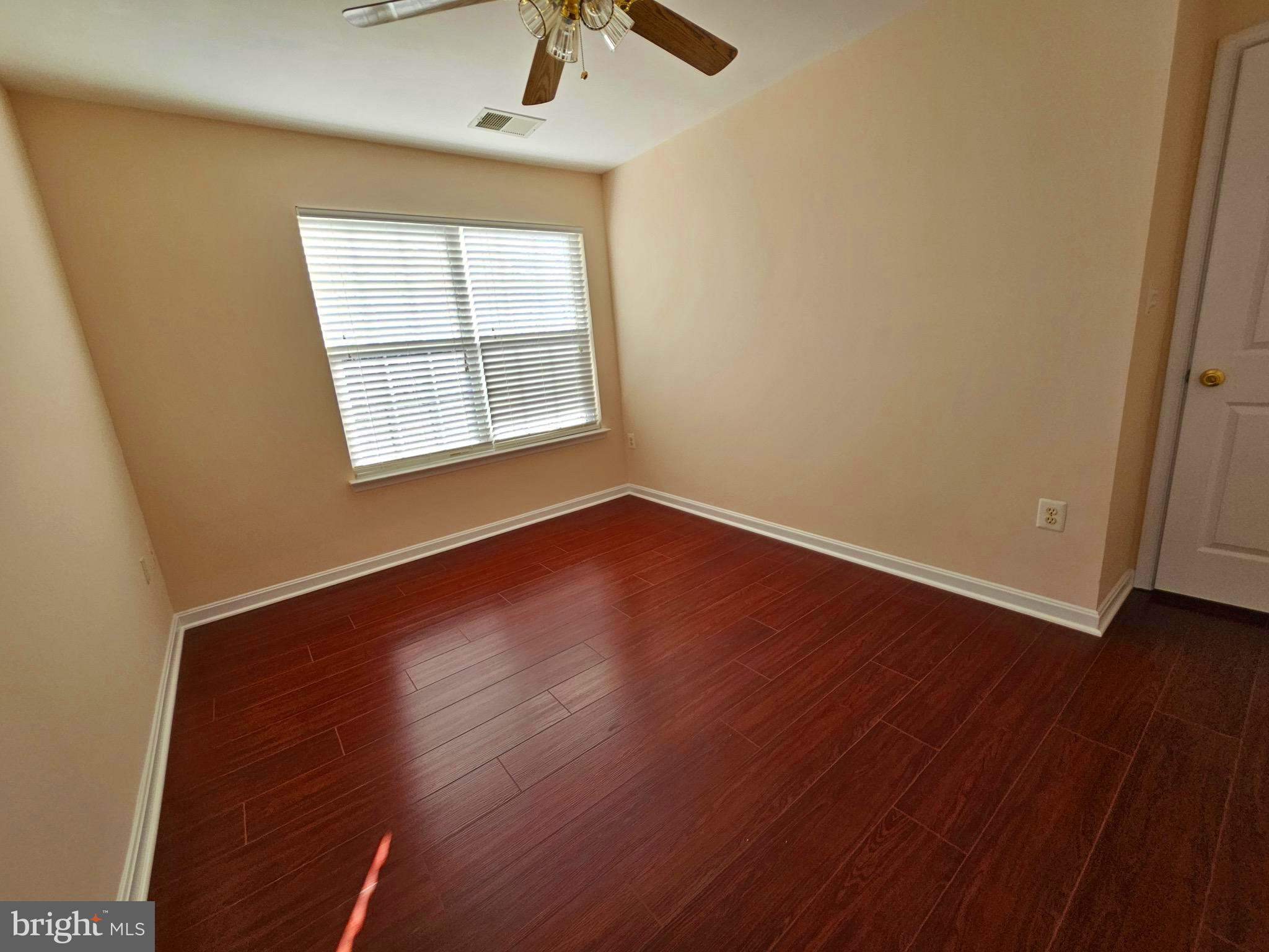 2238 Blue Spruce Drive Culpeper, VA 22701 - Photo 16 of 18 an empty room with wooden floor and windows