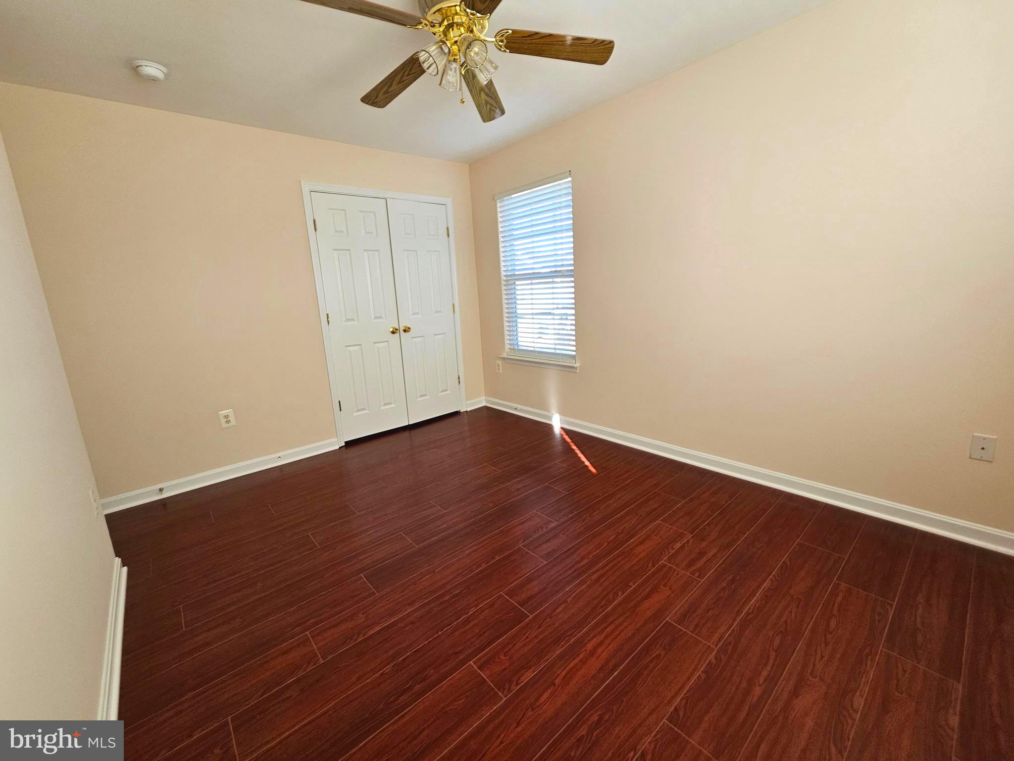 2238 Blue Spruce Drive Culpeper, VA 22701 - Photo 17 of 18 an empty room with wooden floor fan and windows