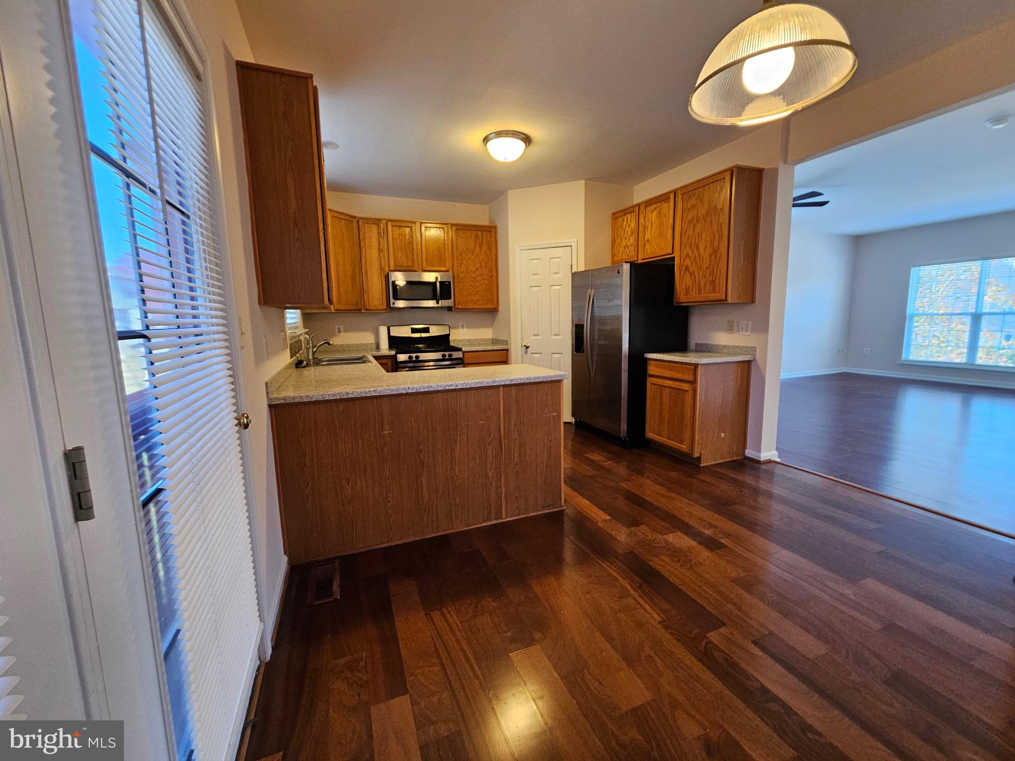 2238 Blue Spruce Drive Culpeper, VA 22701 - Photo 6 of 18 a kitchen with wooden floors and refrigerator