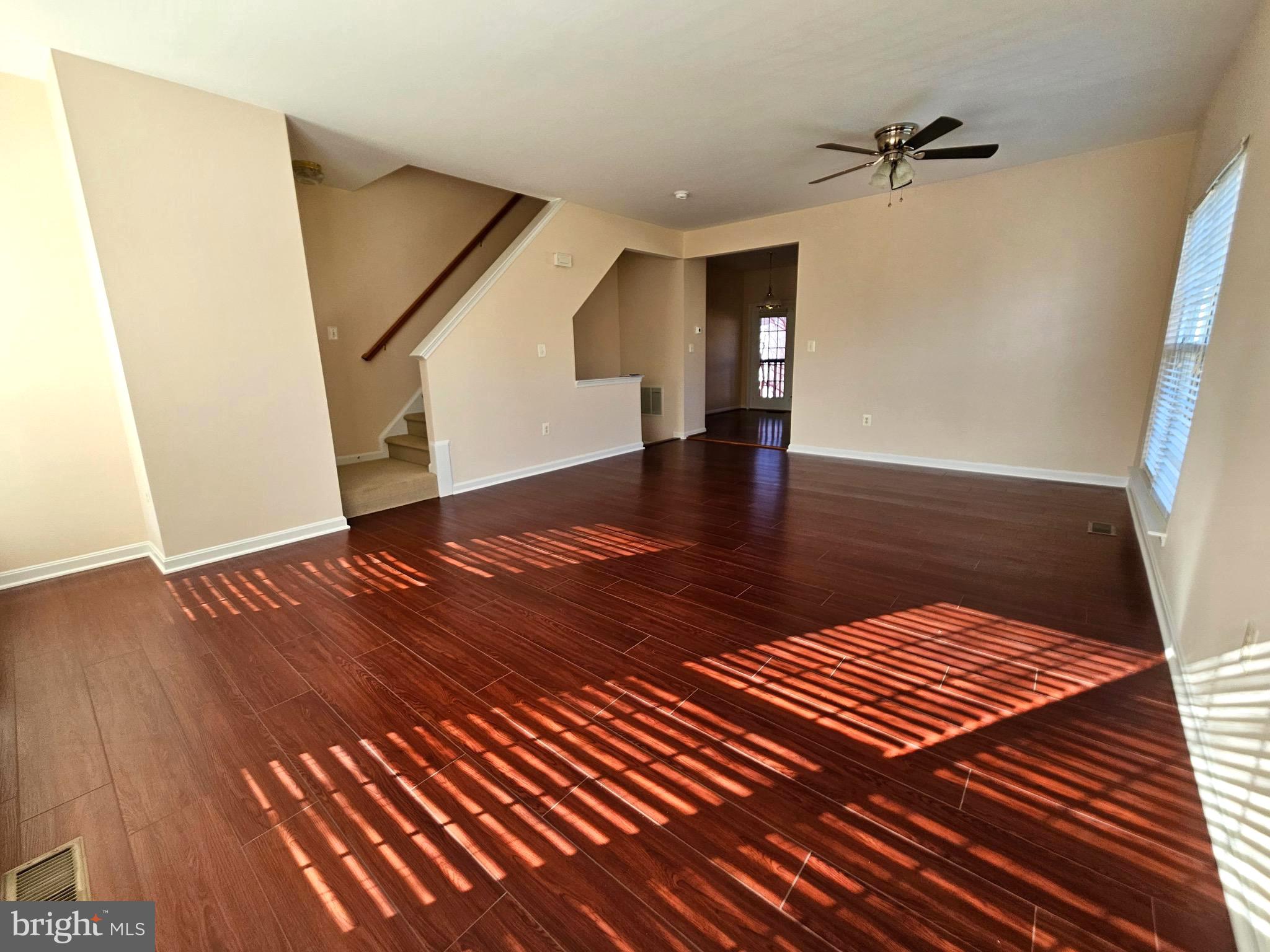 2238 Blue Spruce Drive Culpeper, VA 22701 - Photo 8 of 18 a view of an empty room with wooden floor and a ceiling fan
