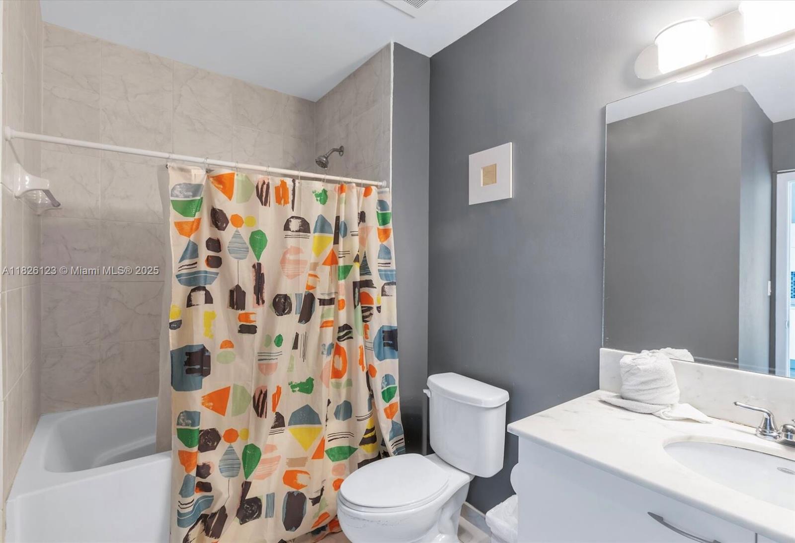 133 Northeast 2nd Avenue, Unit 2015 Miami, FL 33132 - Photo 9 of 14 a white toilet sitting next to a bathroom sink