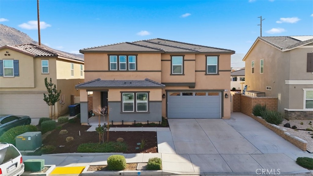 7608 Citrusmoon Court Riverside, CA 92507 - Photo 21 of 25 a front view of a house with garden