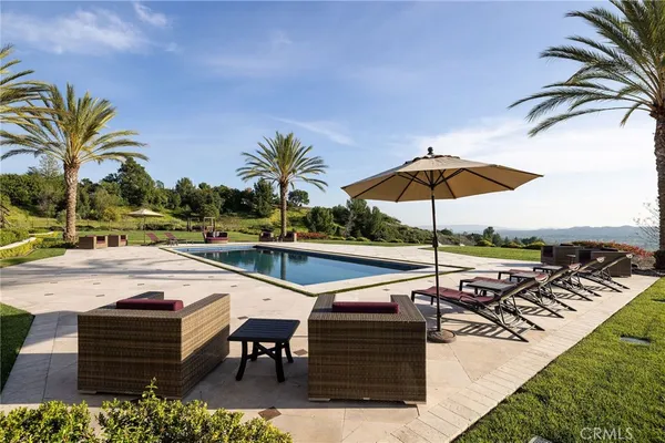 a view of a backyard with sitting area