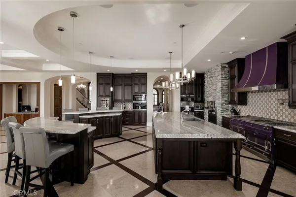 a view of a dining room with furniture a chandelier and wooden floor