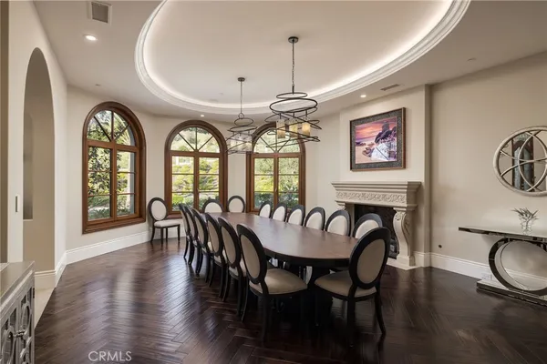 a living room with furniture a flat screen tv and a floor to ceiling window