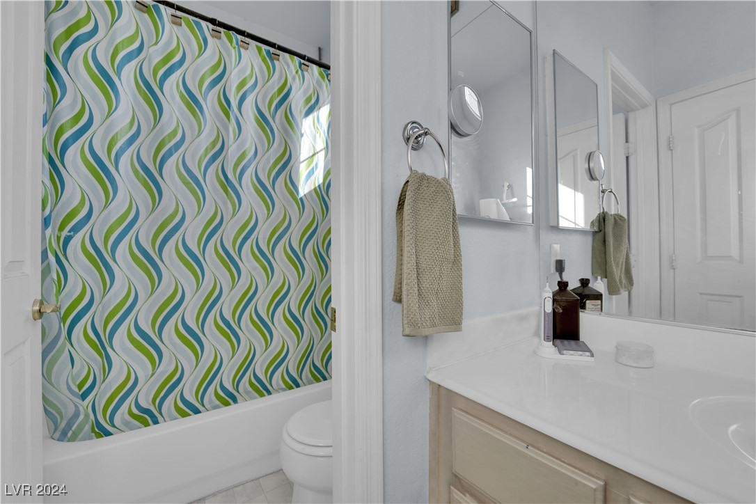 5790 Native Dancer Court Las Vegas, NV 89113 - Photo 16 of 26 Full bathroom featuring vanity, shower / tub combo, and light tile patterned floors