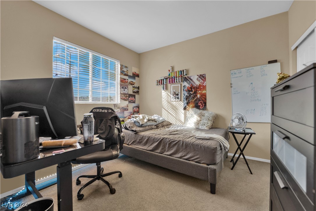 5790 Native Dancer Court Las Vegas, NV 89113 - Photo 17 of 26 Bedroom with light carpet and an office area