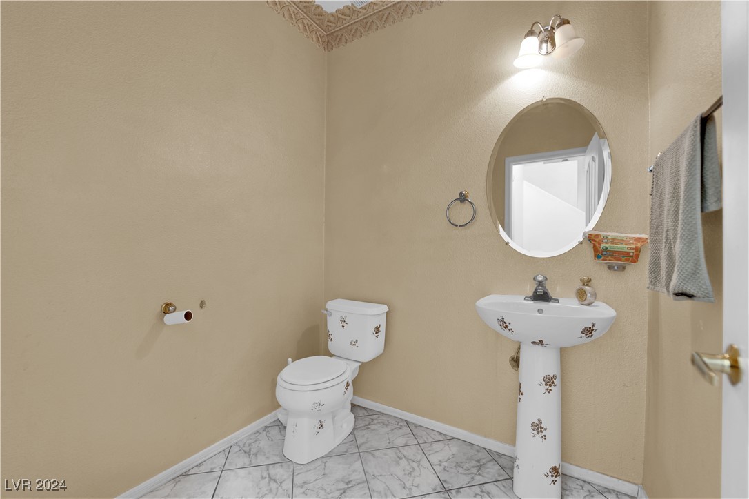 5790 Native Dancer Court Las Vegas, NV 89113 - Photo 23 of 26 Bathroom featuring toilet and light marble finish flooring