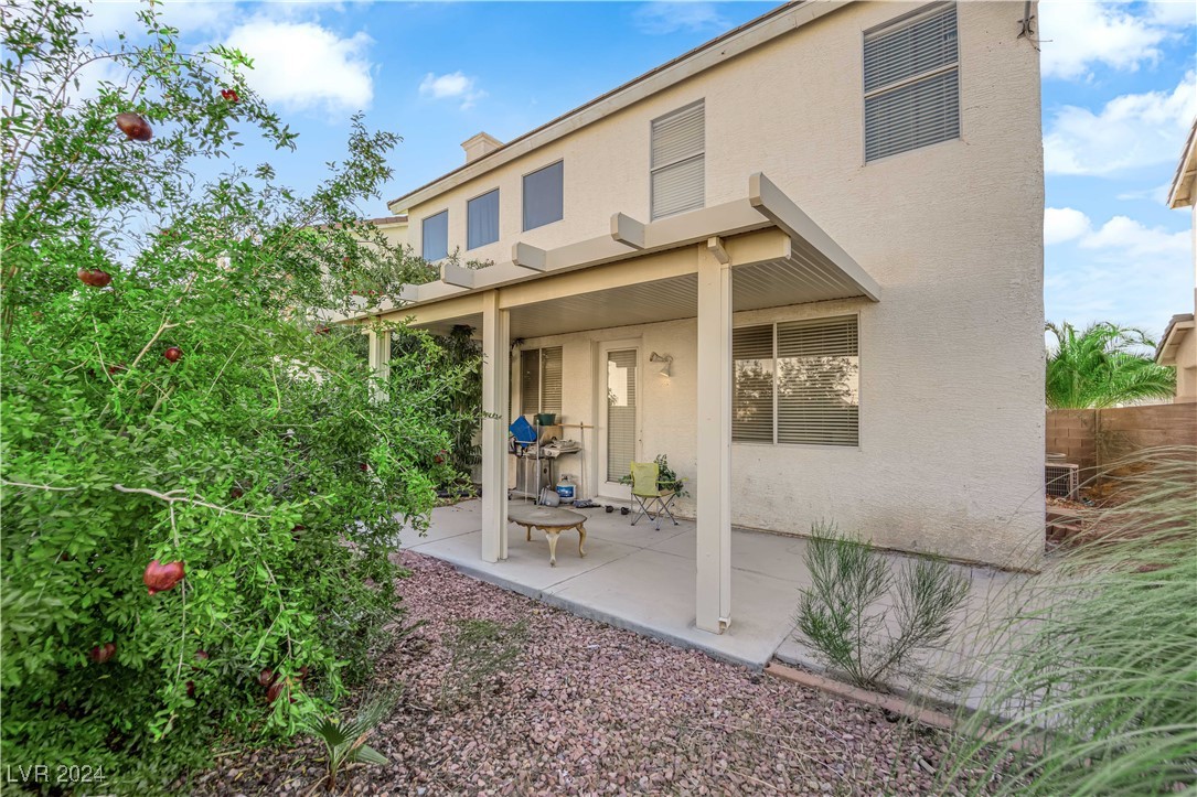 5790 Native Dancer Court Las Vegas, NV 89113 - Photo 26 of 26 Rear view of property with stucco siding, a patio, and a chimney