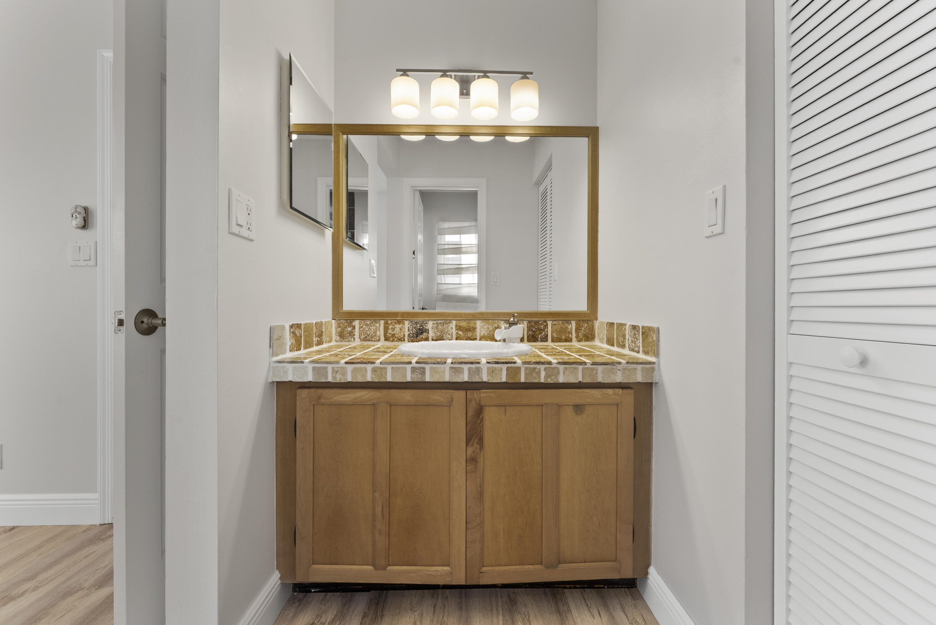 2900 Olivewood Terrace, Unit 2010 Boca Raton, FL 33431 - Photo 15 of 22 a bathroom with a granite countertop sink and a mirror