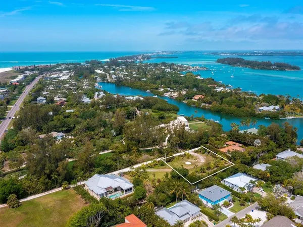 an aerial view of residential house with outdoor space and lake view in back