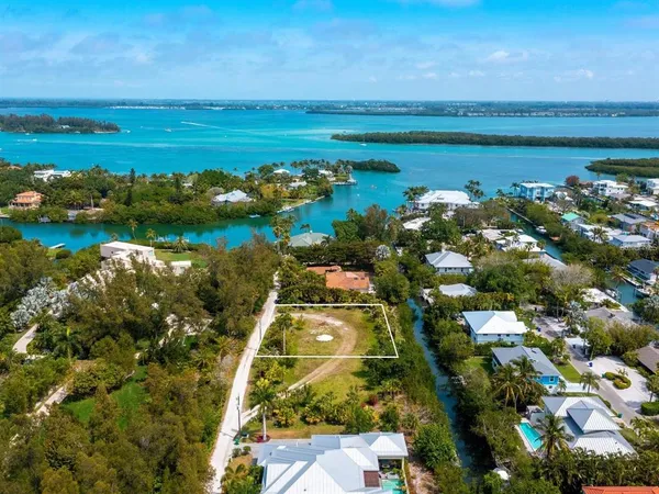 an aerial view of a house with a garden and lake view