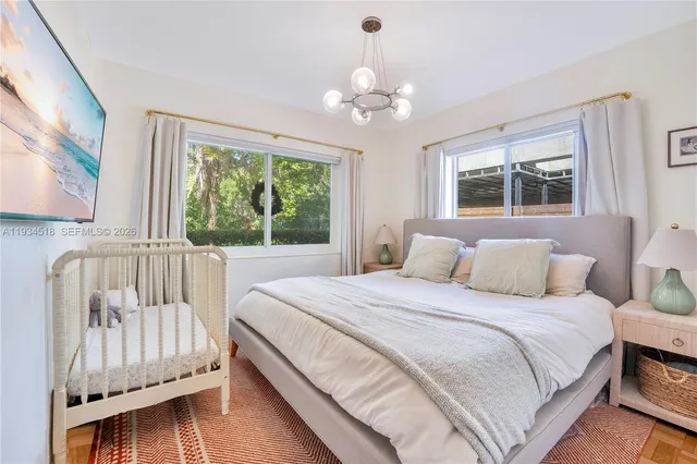 a bedroom with a bed and a large window