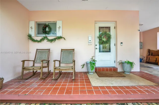 a living room with furniture a rug and a wooden floor