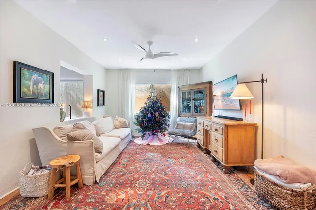 a living room with furniture flowerpot and window