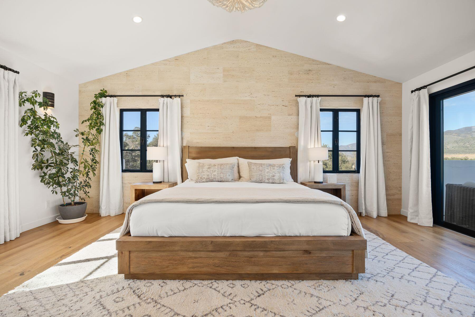 13202 Ojai Road Santa Paula, CA 93060 - Photo 21 of 54 a bedroom with a large bed and a potted plant