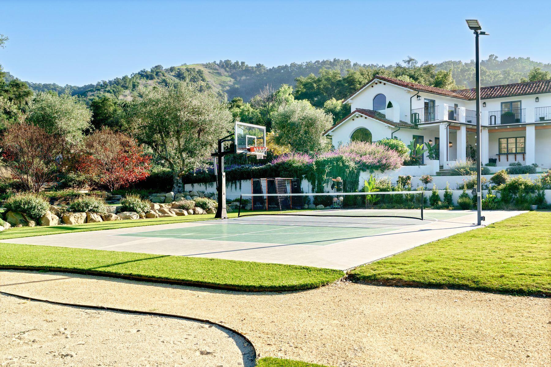 13202 Ojai Road Santa Paula, CA 93060 - Photo 41 of 54 a view of a white house with a big yard and potted plants