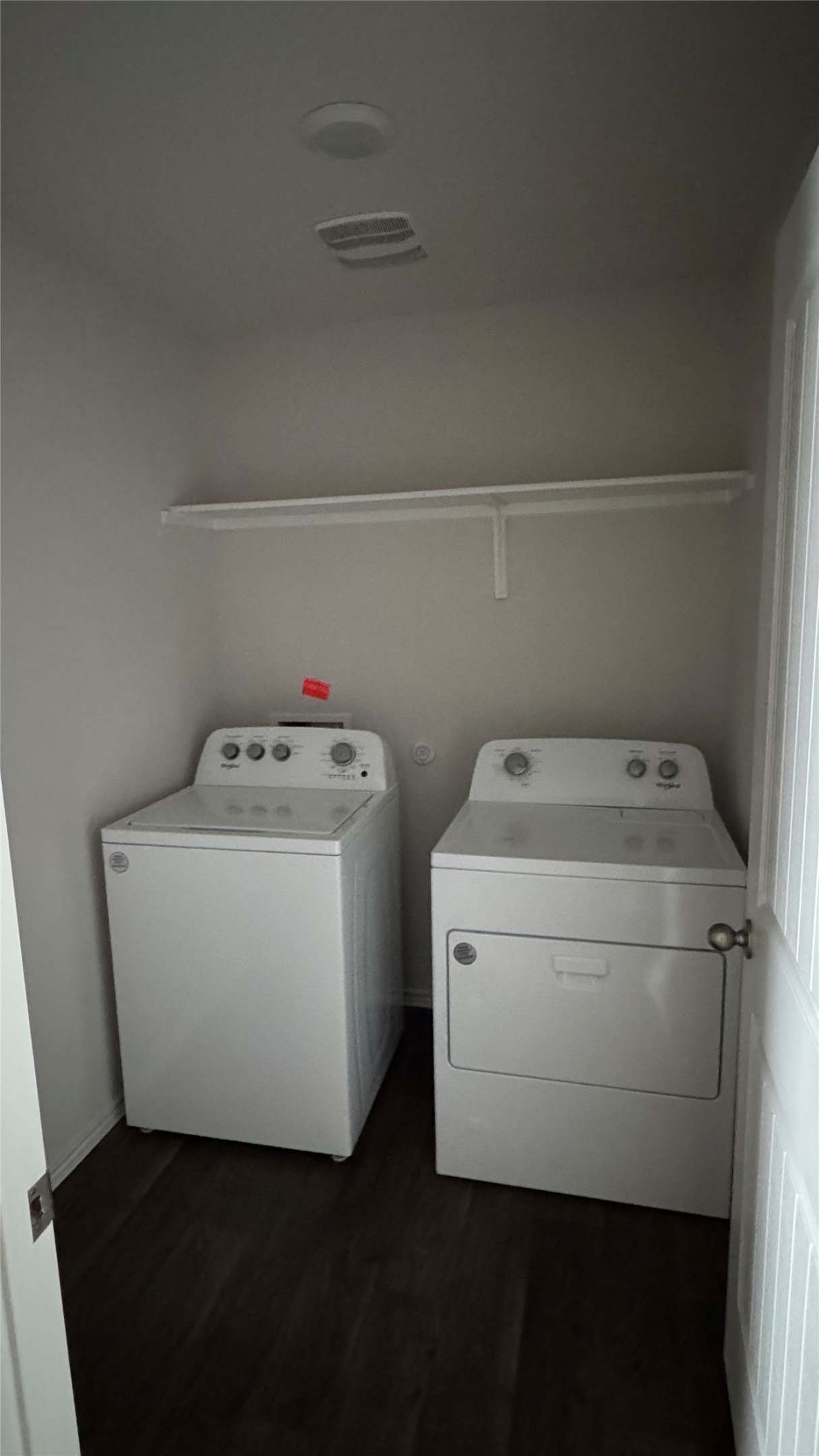 408 Frogmore Loop Kyle, TX 78640 - Photo 23 of 32 Functional laundry space featuring modern appliances and practical shelving.