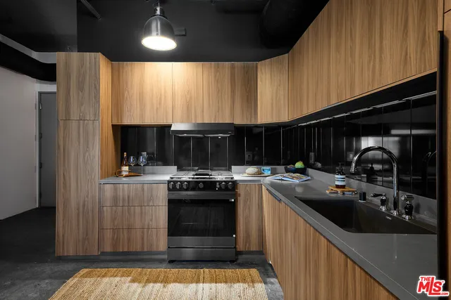 a kitchen with stainless steel appliances granite countertop a stove and a sink