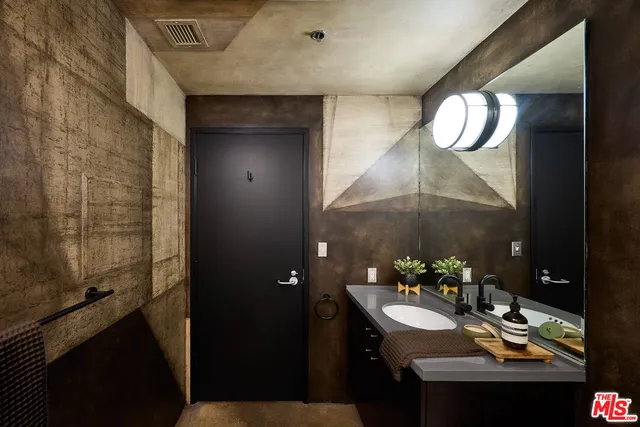 a bathroom with a sink and a mirror