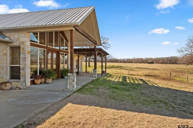a view of a house with backyard and ocean view