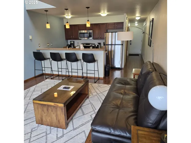 a kitchen with stainless steel appliances kitchen island granite countertop a sink and cabinets