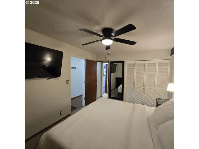 a bedroom with a bed and a flat screen tv