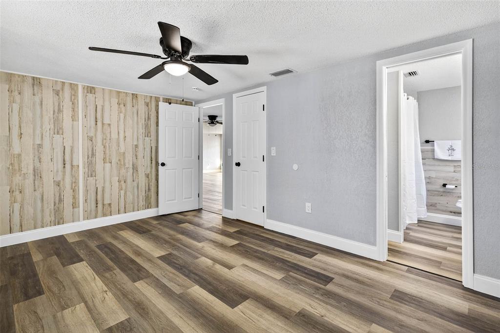 7835 Birchwood Drive Port Richey, FL 34668 - Photo 12 of 14 a view of a livingroom with wooden floor and a ceiling fan