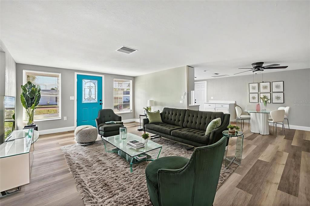 7835 Birchwood Drive Port Richey, FL 34668 - Photo 4 of 14 a living room with furniture wooden floor and a large window