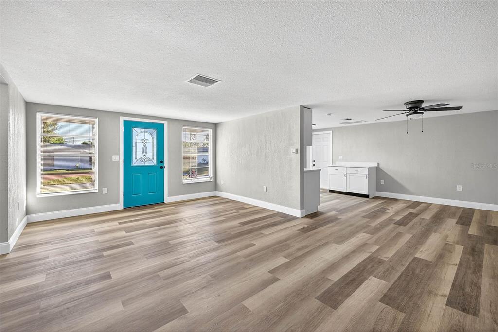 7835 Birchwood Drive Port Richey, FL 34668 - Photo 5 of 14 a view of empty room with wooden floor and window