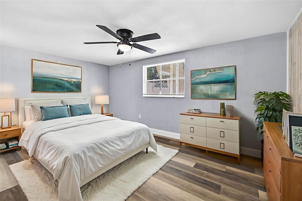 7835 Birchwood Drive Port Richey, FL 34668 - Photo 10 of 14 a spacious bedroom with a bed and a dresser