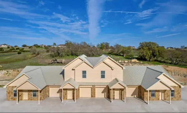 a view of house with yard and mountain view in back
