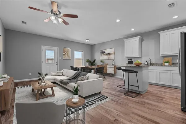 a living room with furniture and kitchen view