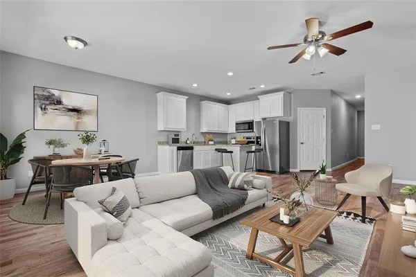 a living room with furniture kitchen view and a dining table