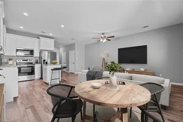 a view of a dining room with furniture and wooden floor