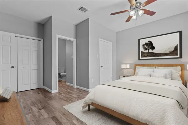 a bedroom with a bed and a chandelier