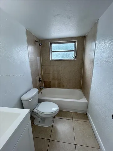 a bathroom with a sink a toilet and bathtub