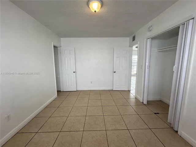 a view of an empty room and window in a room