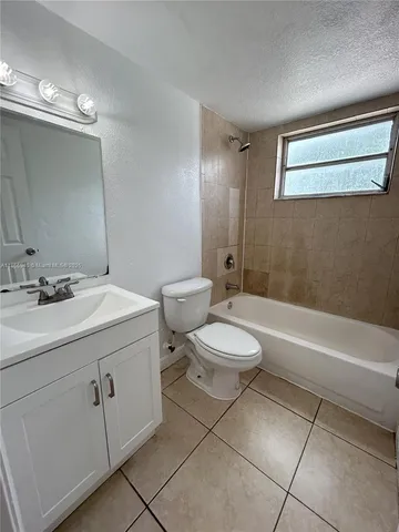 a bathroom with a sink a toilet and bathtub