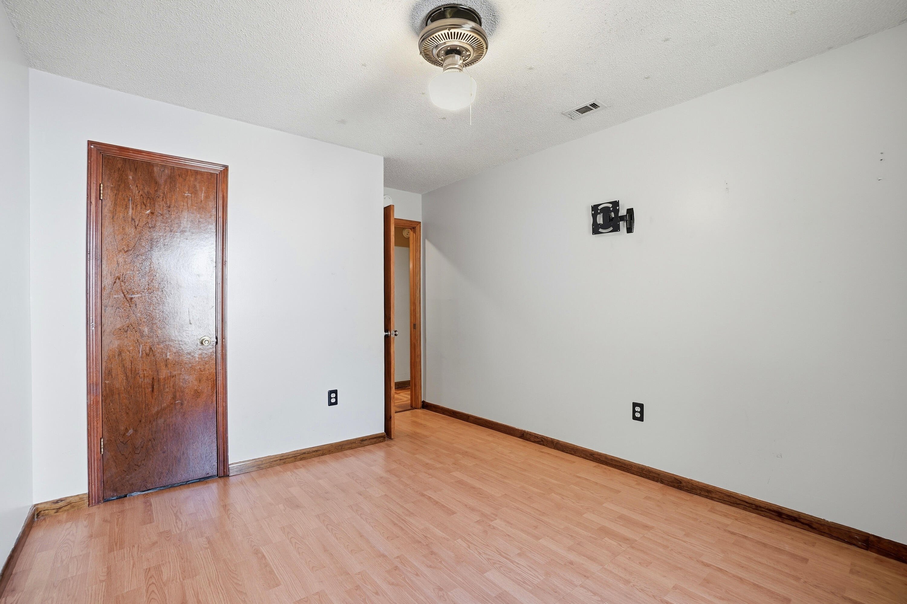 324 John King Road Crestview, FL 32539 - Photo 11 of 28 an empty room with wooden floor and mirror