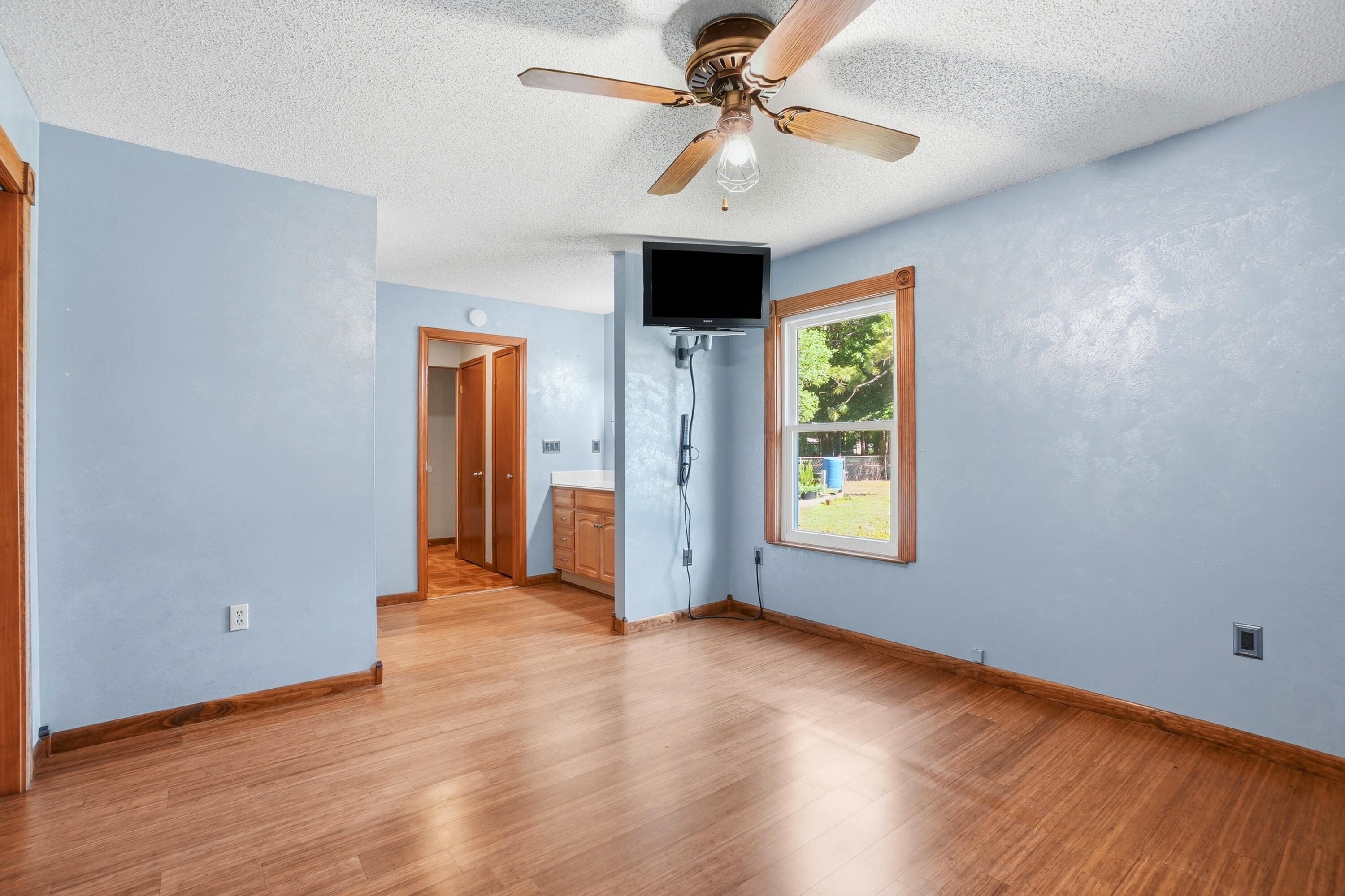 324 John King Road Crestview, FL 32539 - Photo 13 of 28 wooden floor in an empty room with a window
