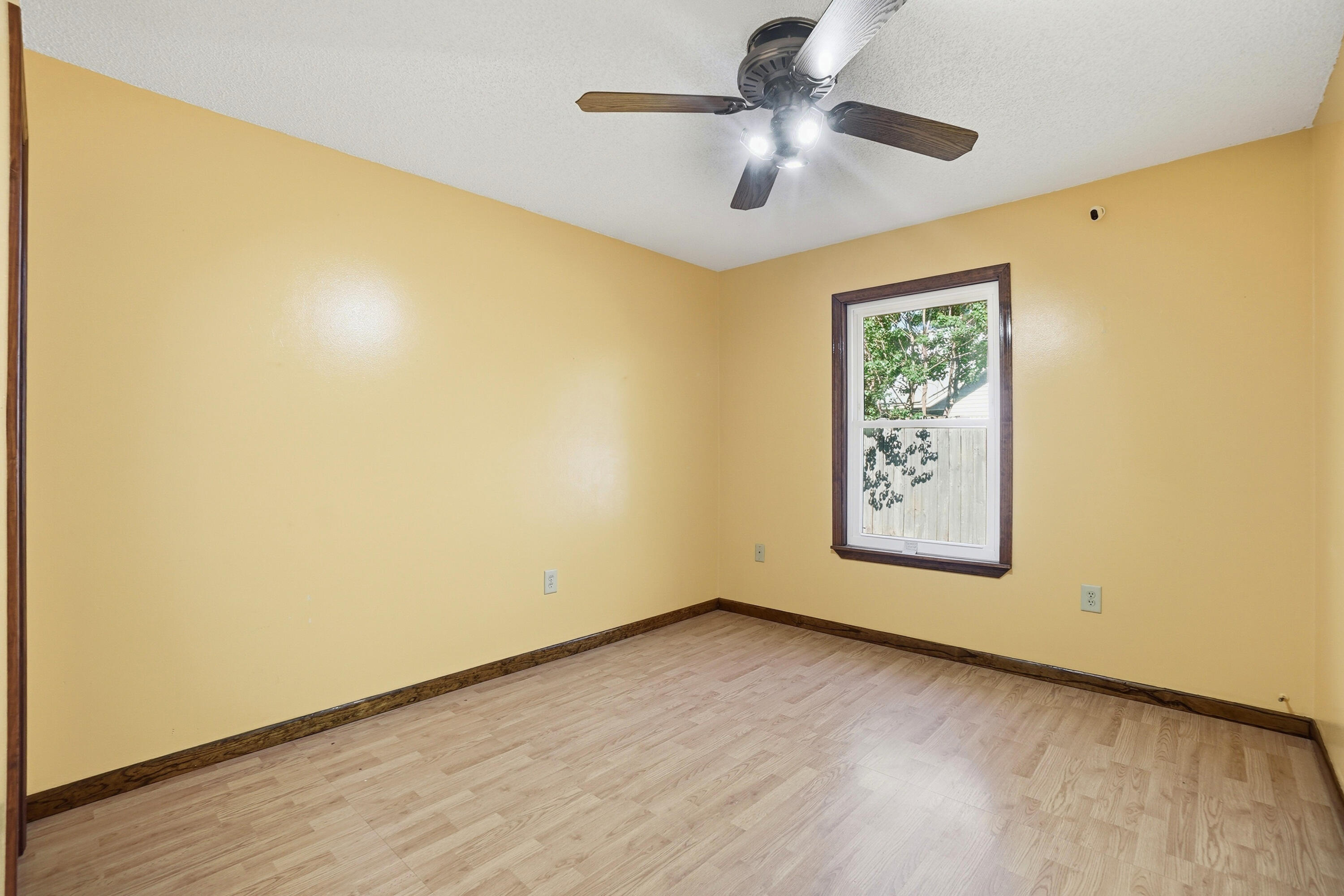 324 John King Road Crestview, FL 32539 - Photo 19 of 28 an empty room with a ceiling fan and a window