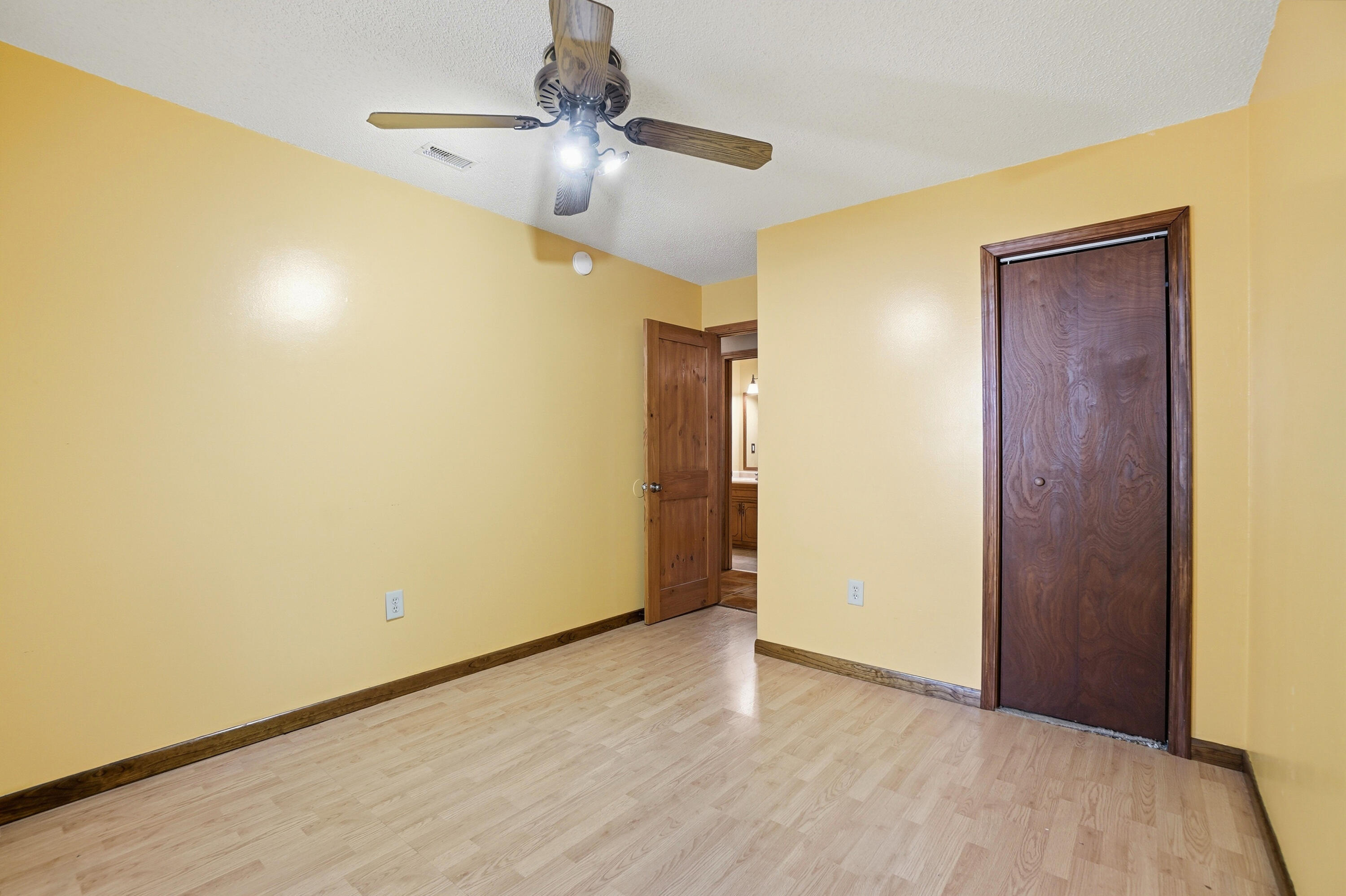 324 John King Road Crestview, FL 32539 - Photo 20 of 28 an empty room with wooden floor closet and windows