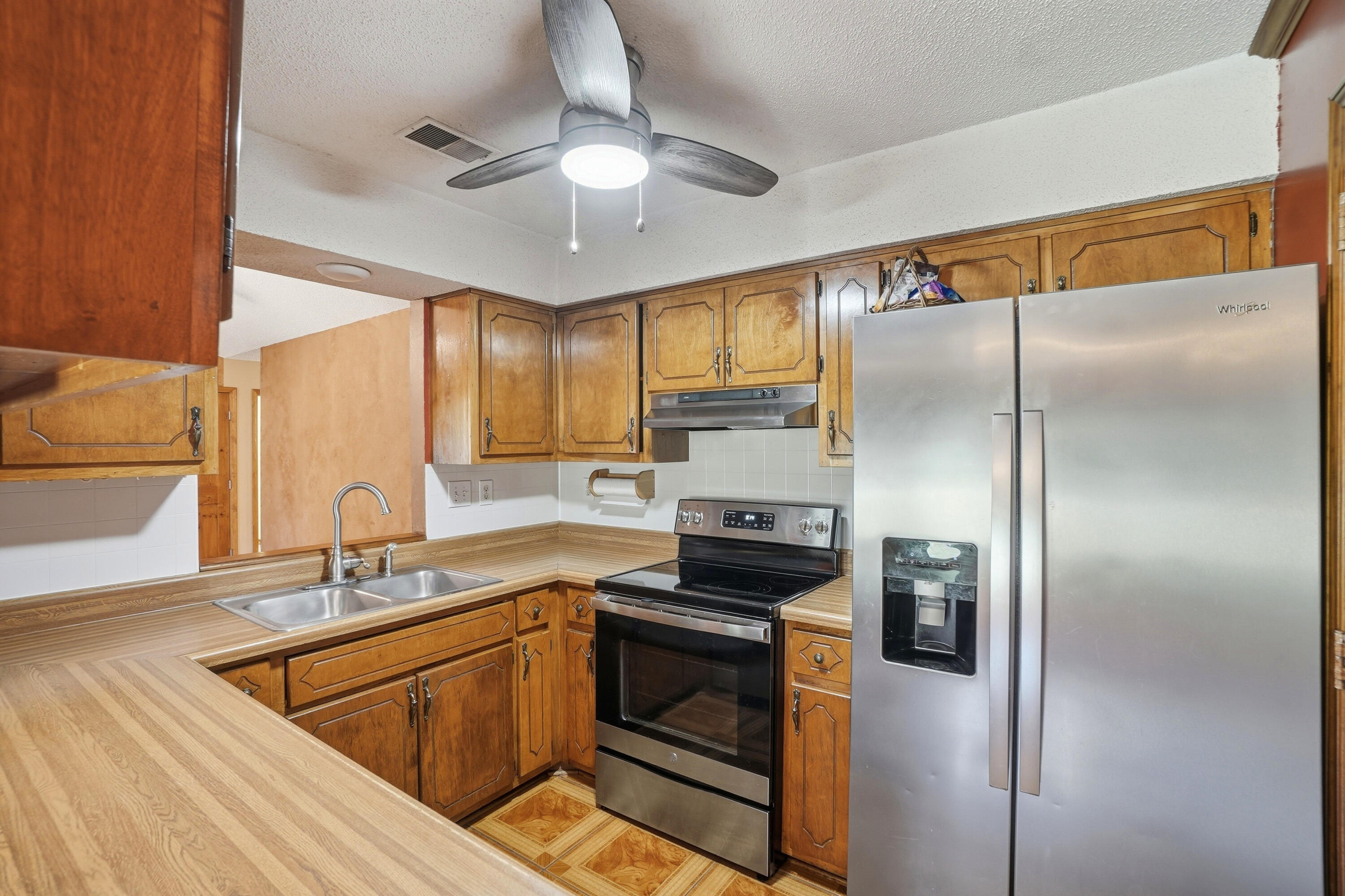 324 John King Road Crestview, FL 32539 - Photo 5 of 28 a kitchen with stainless steel appliances granite countertop a sink a stove and refrigerator