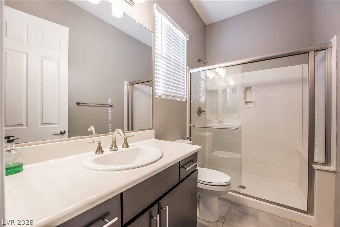 2787 Athens Ridge Drive Henderson, NV 89052 - Photo 12 of 31 A well-appointed bathroom offers a clean vanity and a functional glass-enclosed shower.