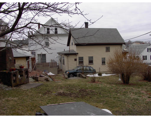 23 Warner Street Gloucester, MA 01930 - Photo 11 of 13 a backyard of a house with barbeque oven table and chairs