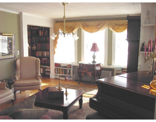 23 Warner Street Gloucester, MA 01930 - Photo 4 of 13 a living room filled with furniture and a large window