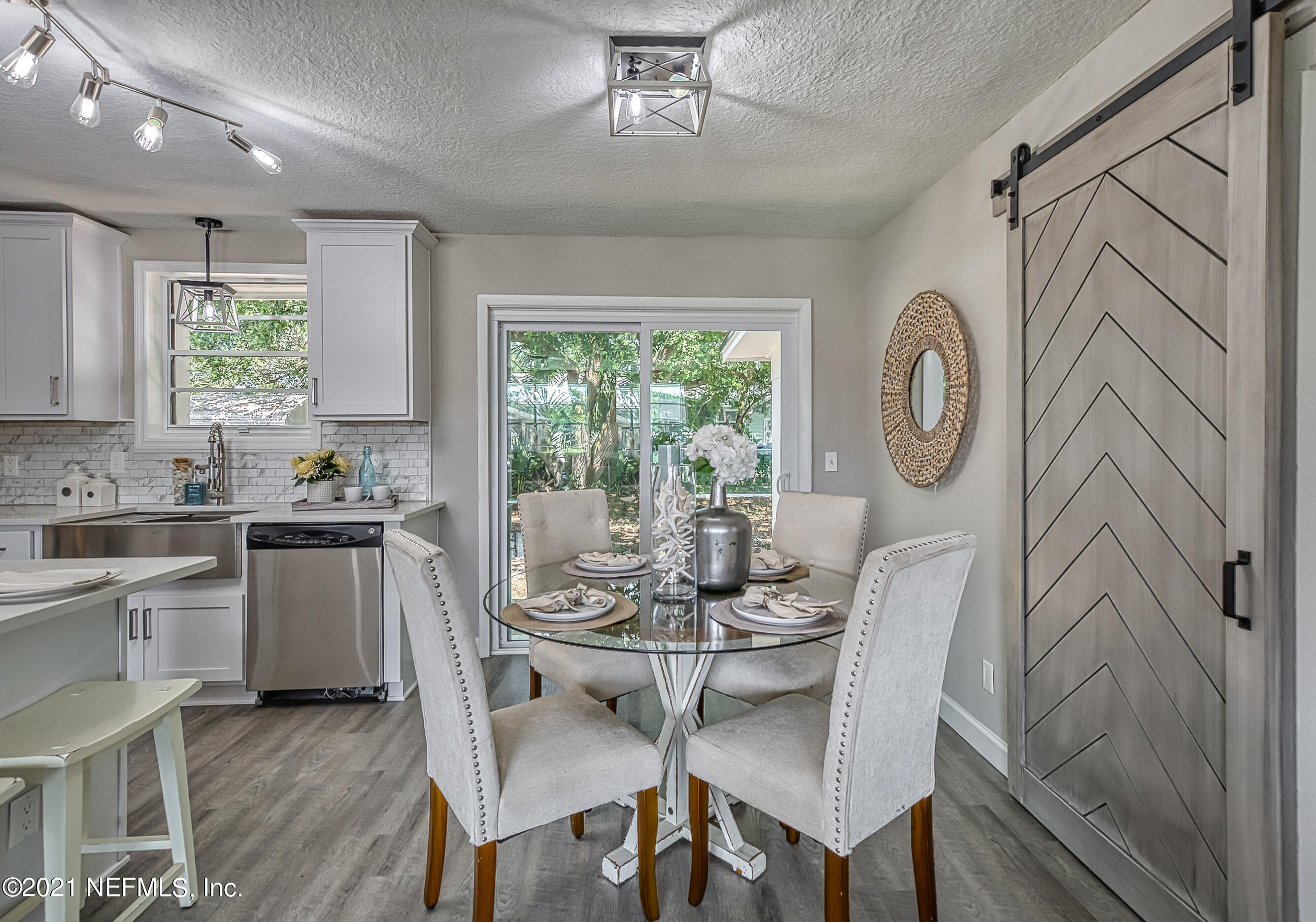 447 Irex Road Atlantic Beach, FL 32233 - Photo 11 of 35 a kitchen with a table chairs sink and cabinets