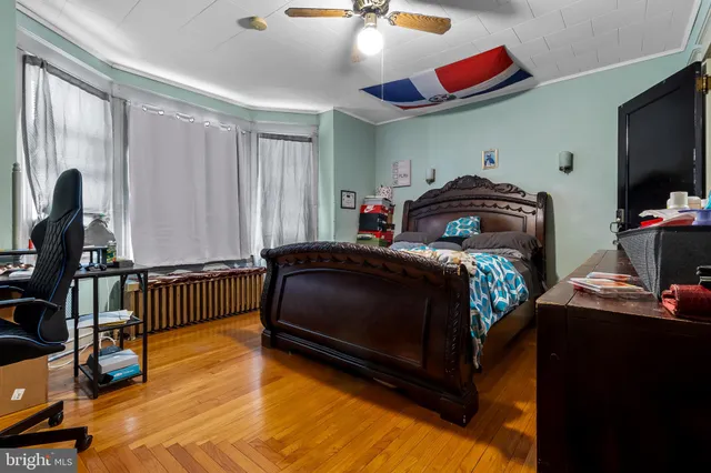 a bedroom with furniture and a flat screen tv